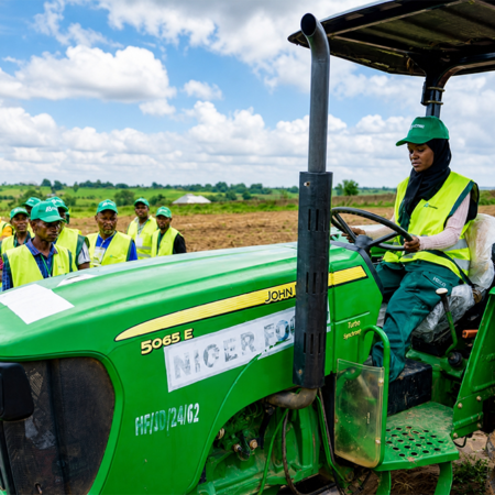 Woman driving a john deer